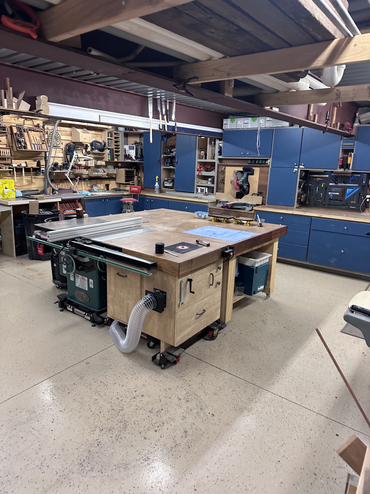 My shop. The Grizzly lives in the center, the Makita lives under the outfeed table. That tells you something about how often each one moves.